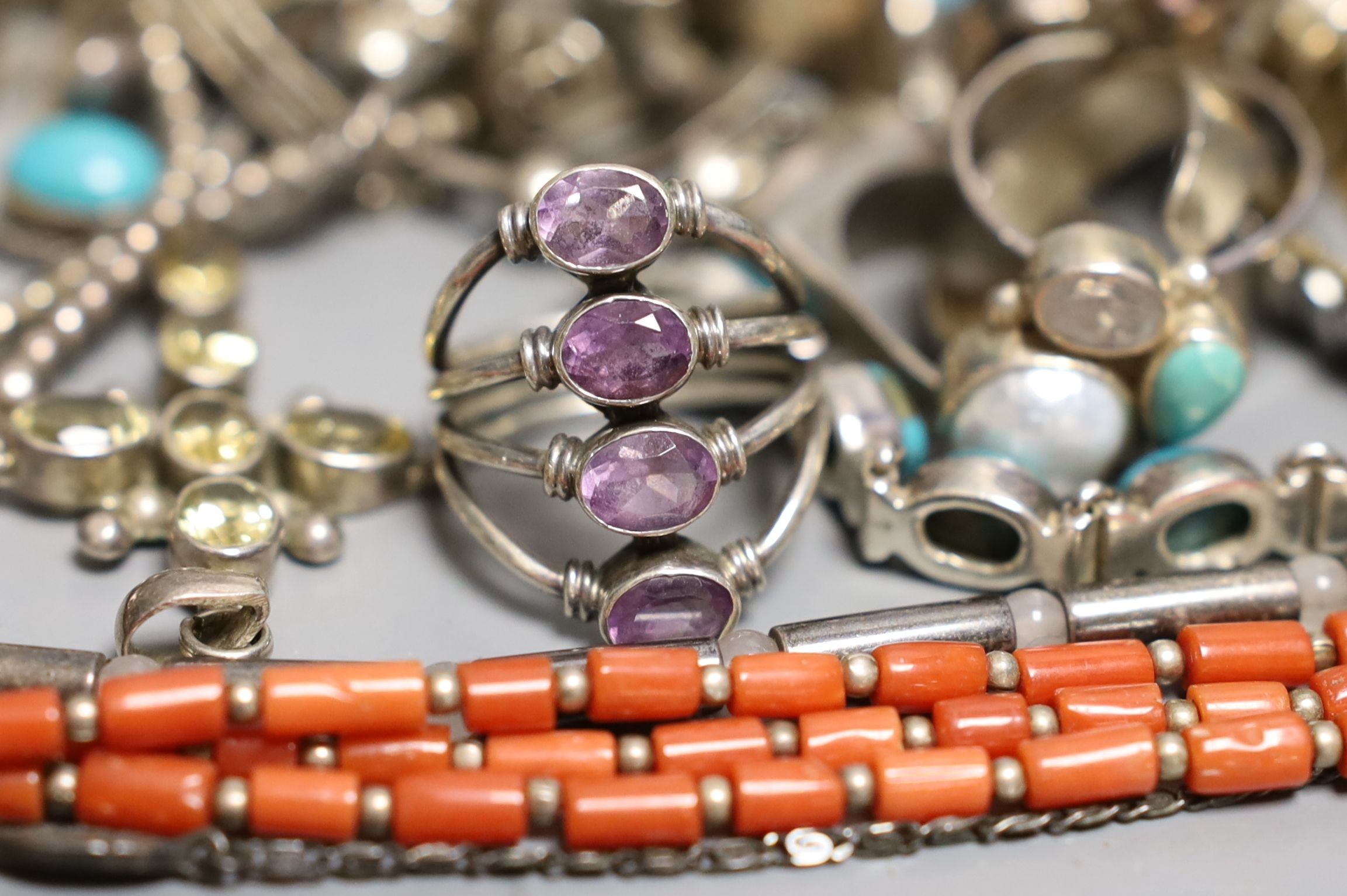 A quantity of mainly modern silver and white metal jewellery including gem set rings.